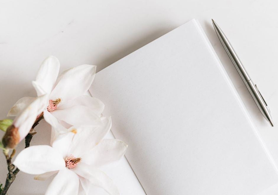 White flowers beside a memorial guestbook for funeral homes Reserve, LA